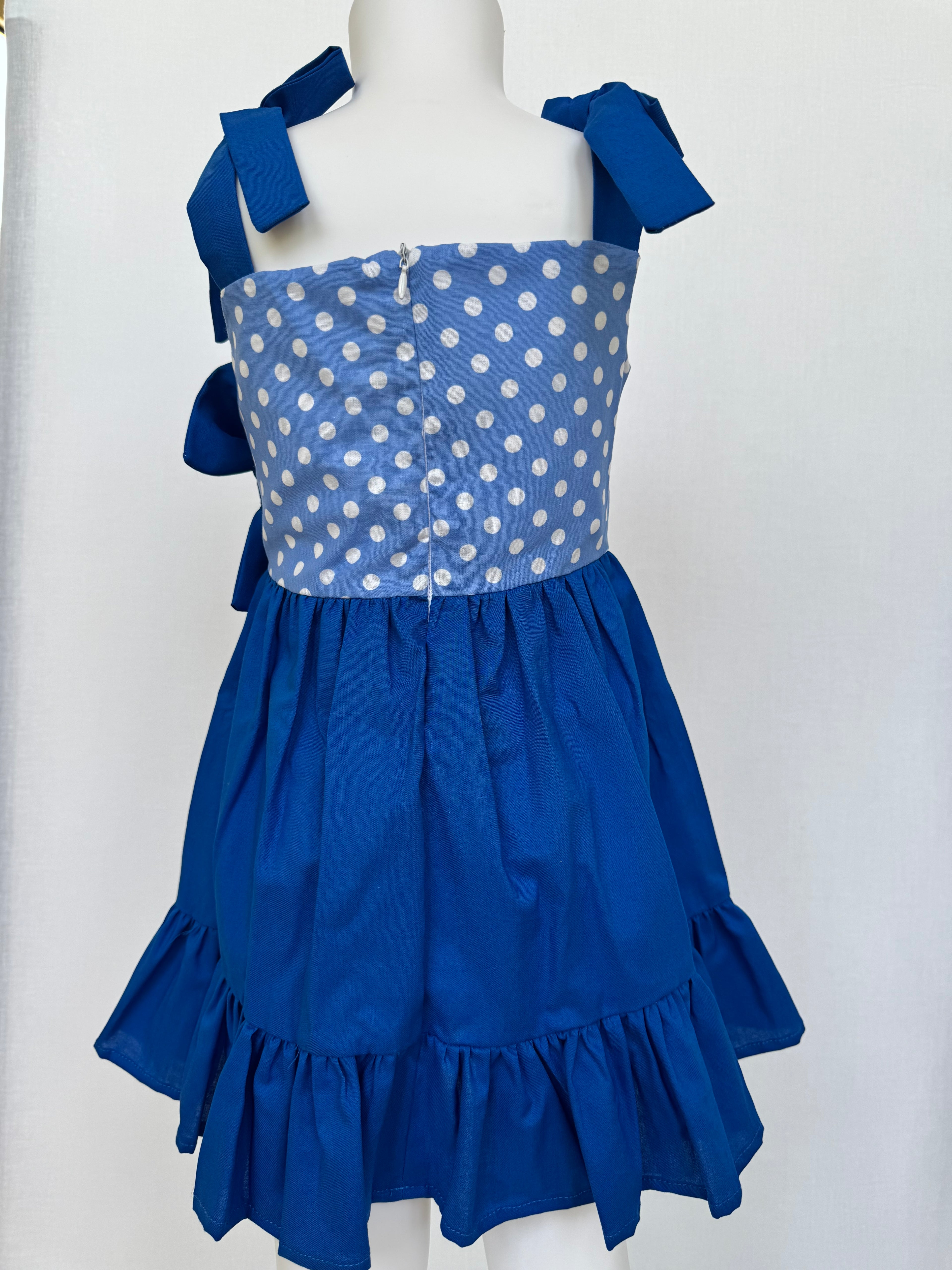 Beautiful kids dress. 👗 Blue with bun included. Handmade by BeasFashions. Comfortable and lightweight material. Adjustable spaghetti straps.