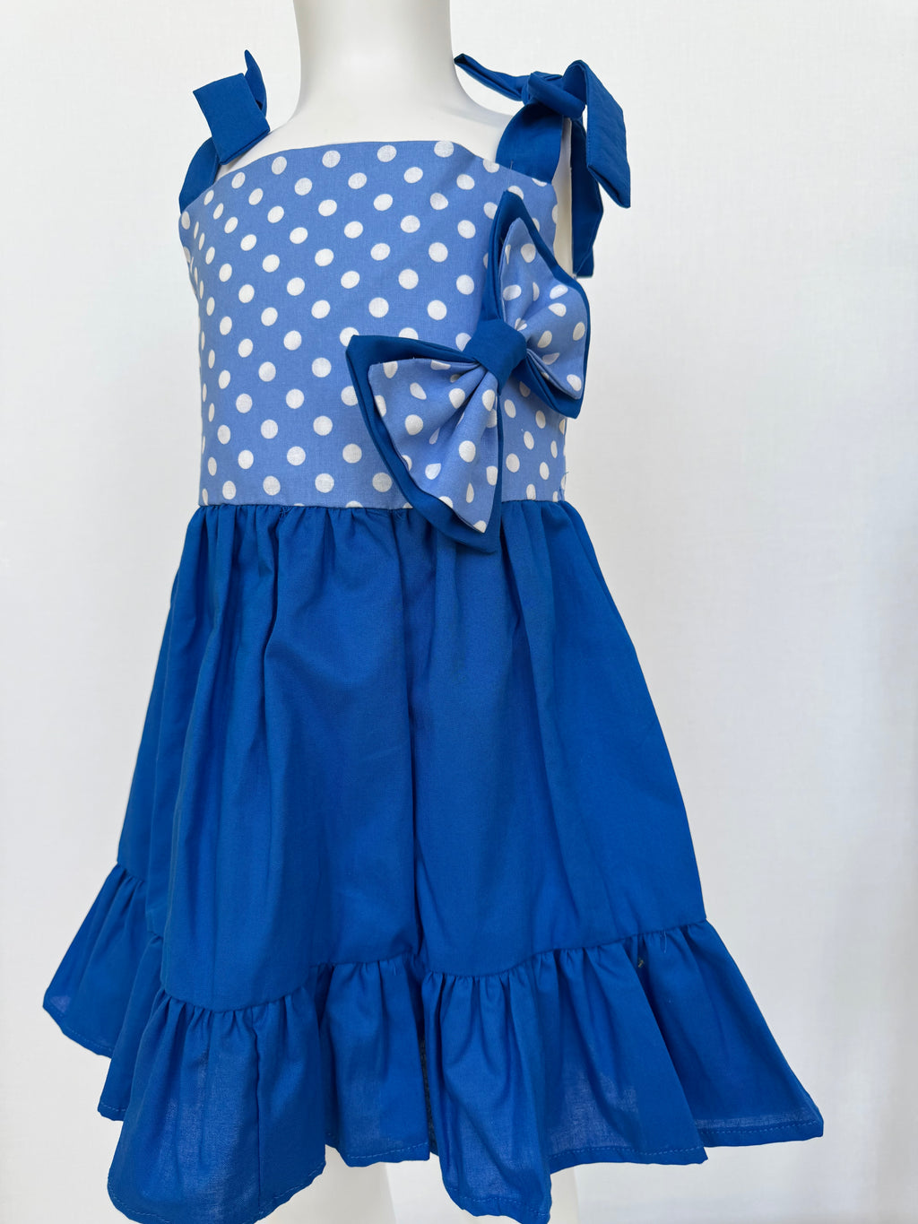 Beautiful kids dress. 👗 Blue with bun included. Handmade by BeasFashions. Comfortable and lightweight material. Adjustable spaghetti straps.